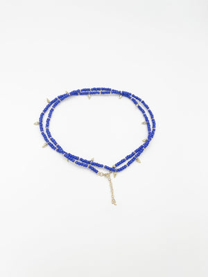 Beads necklace featuring 18 karat gold plated ornaments that can be styled as a bracelet or belt. - ELLY