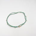 Beads necklace featuring 18 karat gold plated ornaments that can be styled as a bracelet or belt. - ELLY