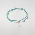 Beads necklace featuring 18 karat gold plated ornaments that can be styled as a bracelet or belt. - ELLY