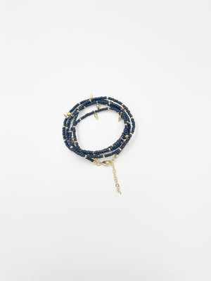 Beads necklace featuring 18 karat gold plated ornaments that can be styled as a bracelet or belt. - ELLY