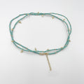 Beads necklace featuring 18 karat gold plated ornaments that can be styled as a bracelet or belt. - ELLY
